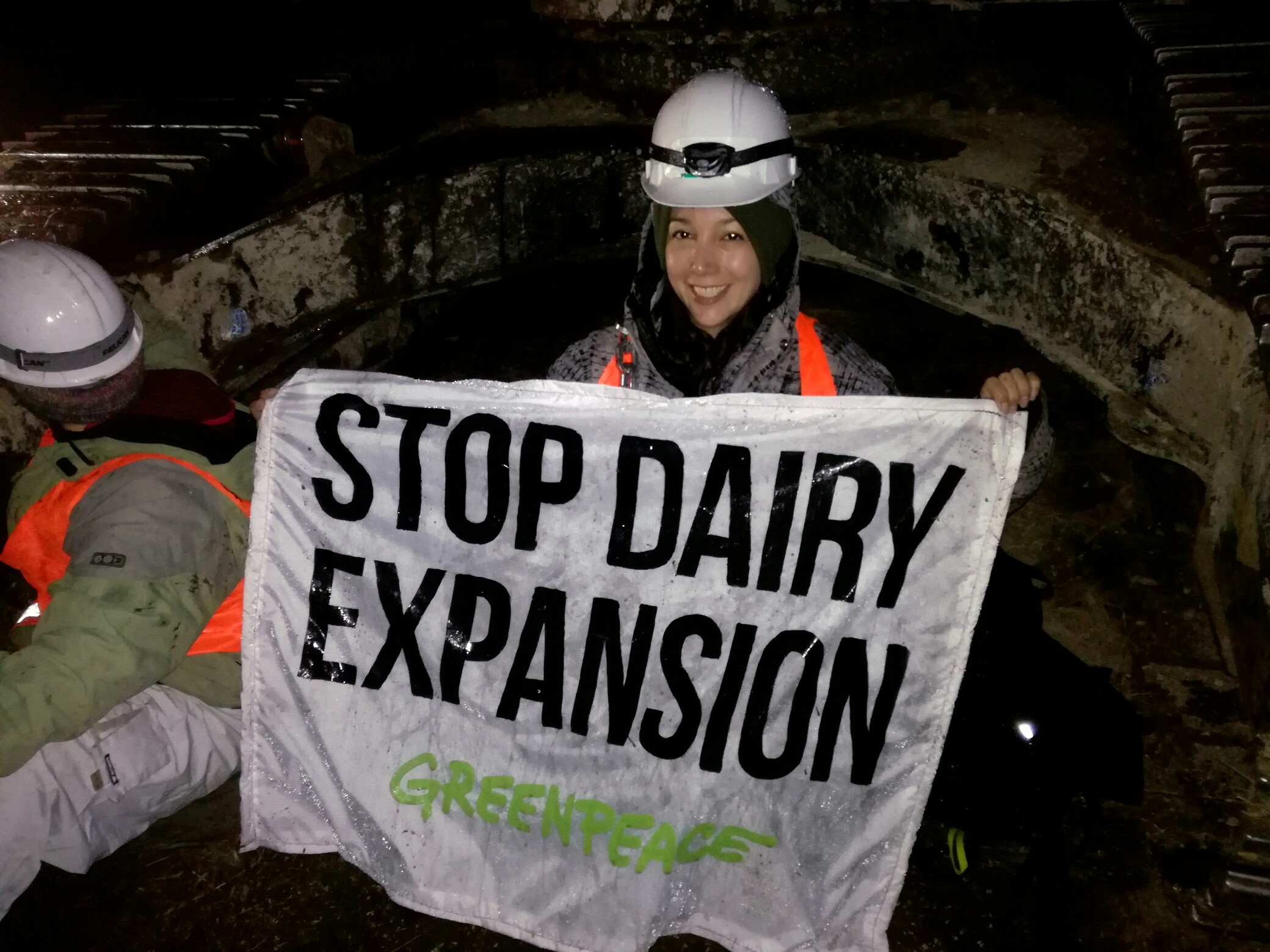 Protestor holds a banner saying 'Stop Dairy Expansion'