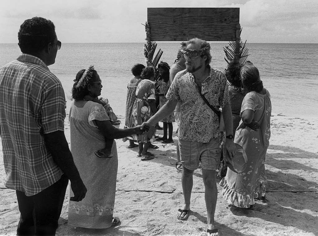 Campaigner Steve Sawyer, is welcomed by inhabitants from Rongelap. The Rainbow Warrior crew is evacuating Rongelap Islanders to Mejato. Rongelap suffered nuclear fallout from US nuclear tests done from 1946 – 1958, making it a hazardous place to live. The health of many adults and children has suffered as a result. The Greenpeace crew took adults, children and 100 tonnes of belongings onboard. 