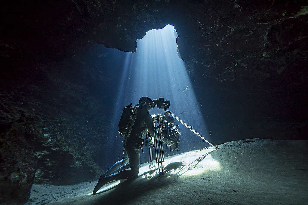 diver filming under water