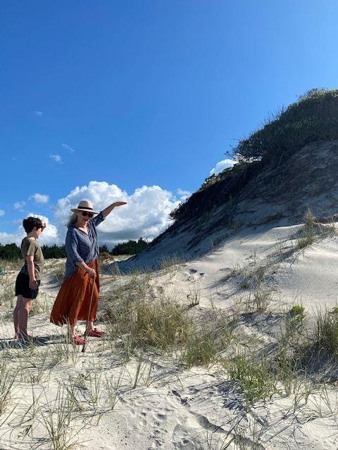 My mum showing my son the small Pohutakawa tree she planted 35 years ago - where she stands used to be a giant sand dune on the hill