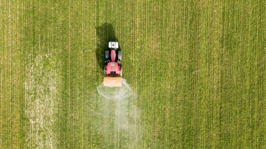 aerial view of a tractor spraying fertiliser