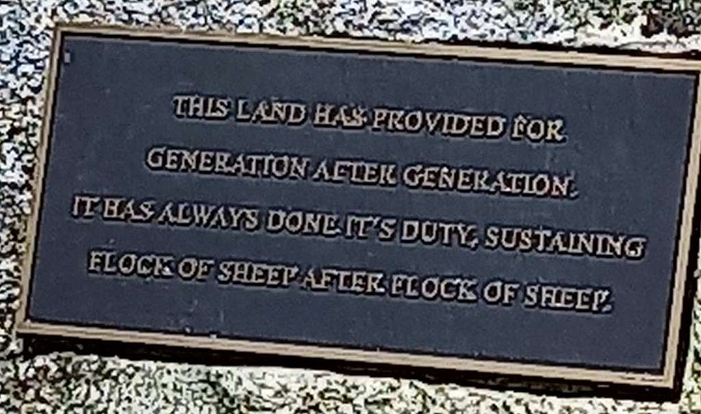A plaque says: This land has provided for generation after generation. it has always done it's duty, sustaining flock of sheep after flock of sheep.