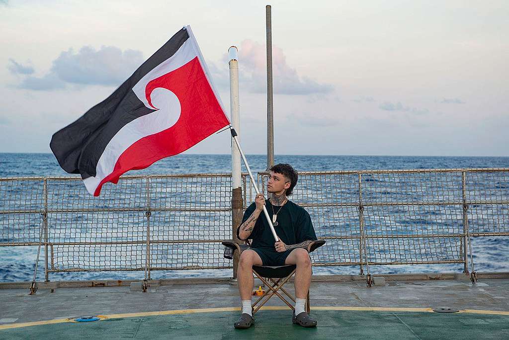 Pacific activist Quack Pirihi flys the Tino Rangatiratanga flag, also known as the national Māori flag, onboard the Arctic Sunrise heading to the ISA in Jamaica. 
