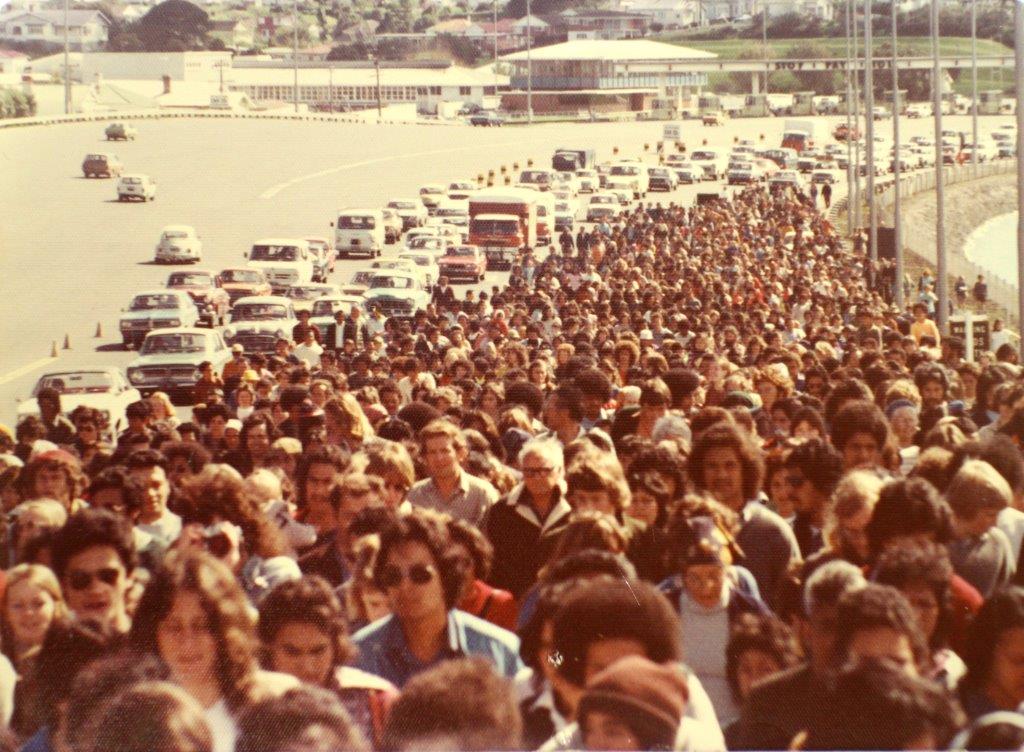 Māori land march, 1975 On 13 October 1975, a hikoi of 5,000 marchers arrived at Parliament to protest the ongoing alienation of Māori land. Organised by Māori land rights group Te Rōpū O Te Matakite and led by Dame Whina Cooper, the hikoi had departed from Te Hapua, Northland, on 14 September, and arrived in Wellington after marching 1,100 kms throughout the North Island. Te Rōpū O Te Matakite regarded the land march as ‘a climax to over a hundred and fifty years of frustration and anger over the continuing alienation of their lands’. Upon their arrival at Parliament they presented a petition signed by 60,000 people from around New Zealand to Prime Minister Bill Rowling. The petition called for an end to monocultural land laws which excluded Māori cultural values, and asked for the ability to establish legitimate communal ownership of land within iwi. The hikoi represented a watershed moment in the burgeoning Māori cultural renaissance of the 1970s. It brought unprecedented levels of public attention to the issue of alienation of Māori land, and established a method of protest that was repeatedly reused in the following decades. To mark the 40th anniversary of the Land March, Archives New Zealand has created an album on Flickr to highlight key documents within our holdings that relate to the event. These include the petition with 60,000 signatures presented by Dame Whina Cooper to Prime Minister Bill Rowling, images of the Land March approaching Wellington City and correspondence related to the planning that went on behind the scenes to support the march taking place. This Ministry of Works photograph shows the tail of the 1975 Māori Land March crossing the Auckland Harbour Bridge. It comes from the Auckland Office of Archives New Zealand. Archives Reference: BCCH 10887-1s Material from Archives New Zealand