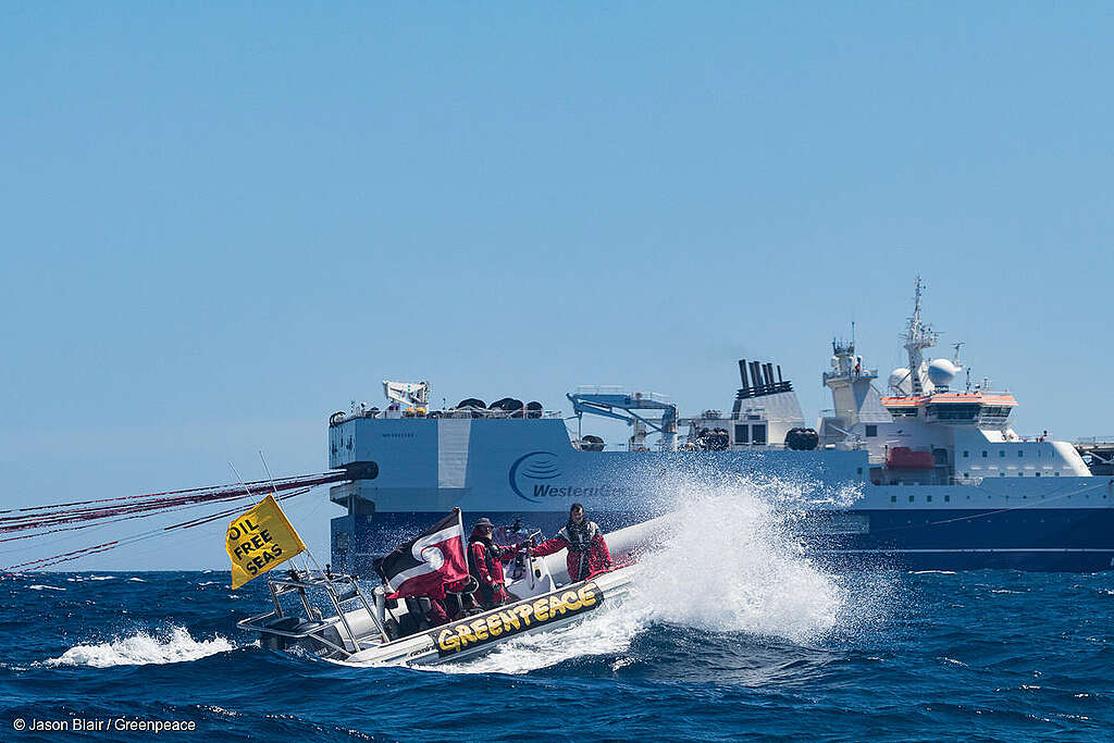 In two small boats, Greenpeace activists and members of the local iwiw opposed to deep sea oil drilling traveled 50 nautical miles off the coast of Wairarapa and intercepted the 125-metre seismic ship, Amazon Warrior, searching for oil off the East Coast of New Zealand on behalf of oil giants Statoil and Chevron. They flew the Tino Rangatiratanga flag along with an Oil Free Seas banner. Greenpeace campaigner Kate Simcock radioed the master of the Amazon Warrior to deliver in full an open letter of protest signed by over 60,000 New Zealanders, and Polynesian voyaging waka captain and East Coast resident, Reuben Raihania Tipoki (Ngāti Kahungunu), delivered a message on behalf of over 80 indigenous communities from the East Coast of Aotearoa, demanding Statoil and Chevron cease activities in their customary waters.