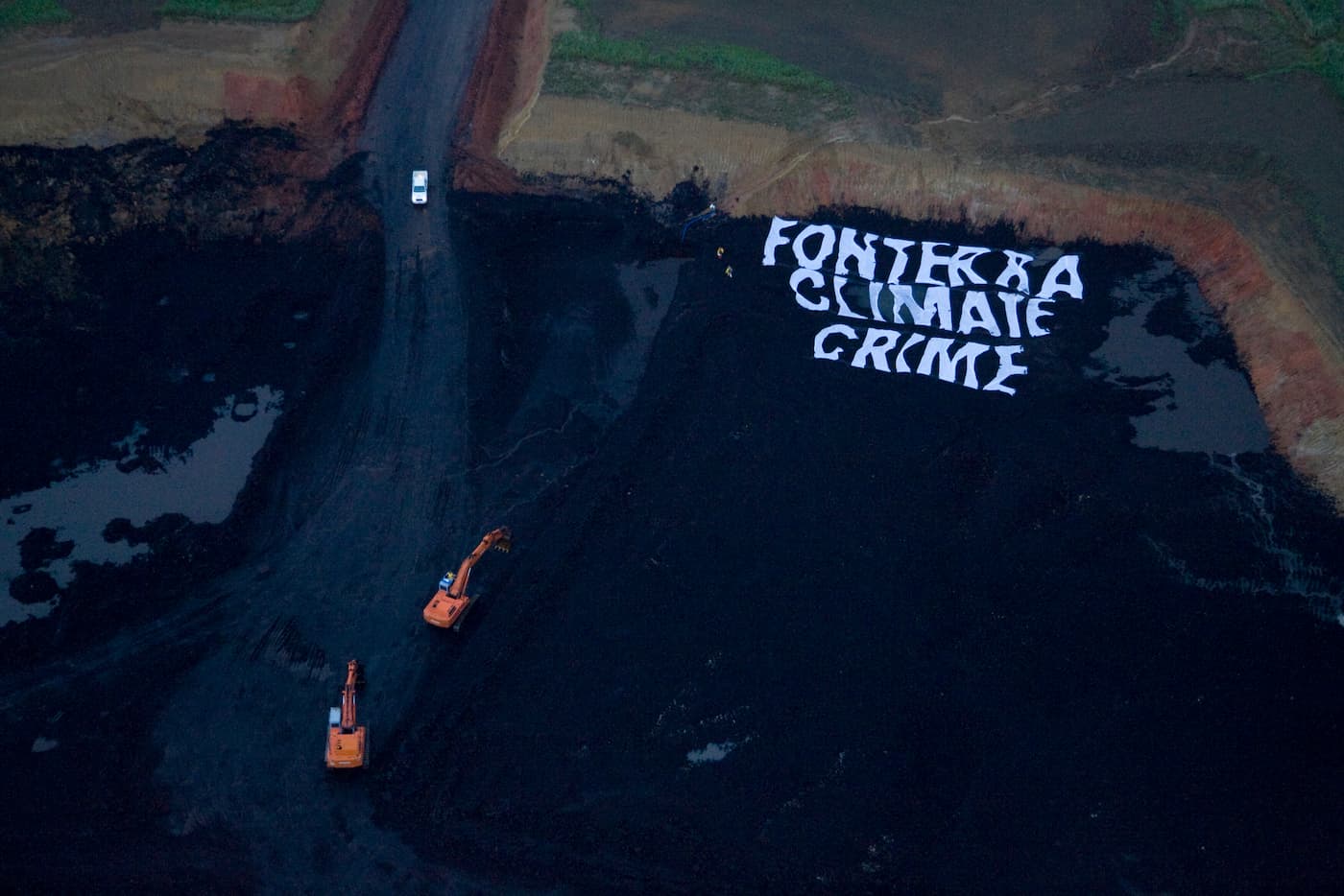 Greenpeace activists shut down a pit of a New Vale lignite coal mine near Invercargill, used by Fonterra to help fuel operations at its nearby Edendale dairy factory, labelling it a Fonterra Climate Crime. At dawn, activists unfurled a massive 40×40 meter banner reading Fonterra Climate Crime on the ground of the opencast mine. Other activists blocked one of the entrances and locked themselves onto some of the mine’s machinery.