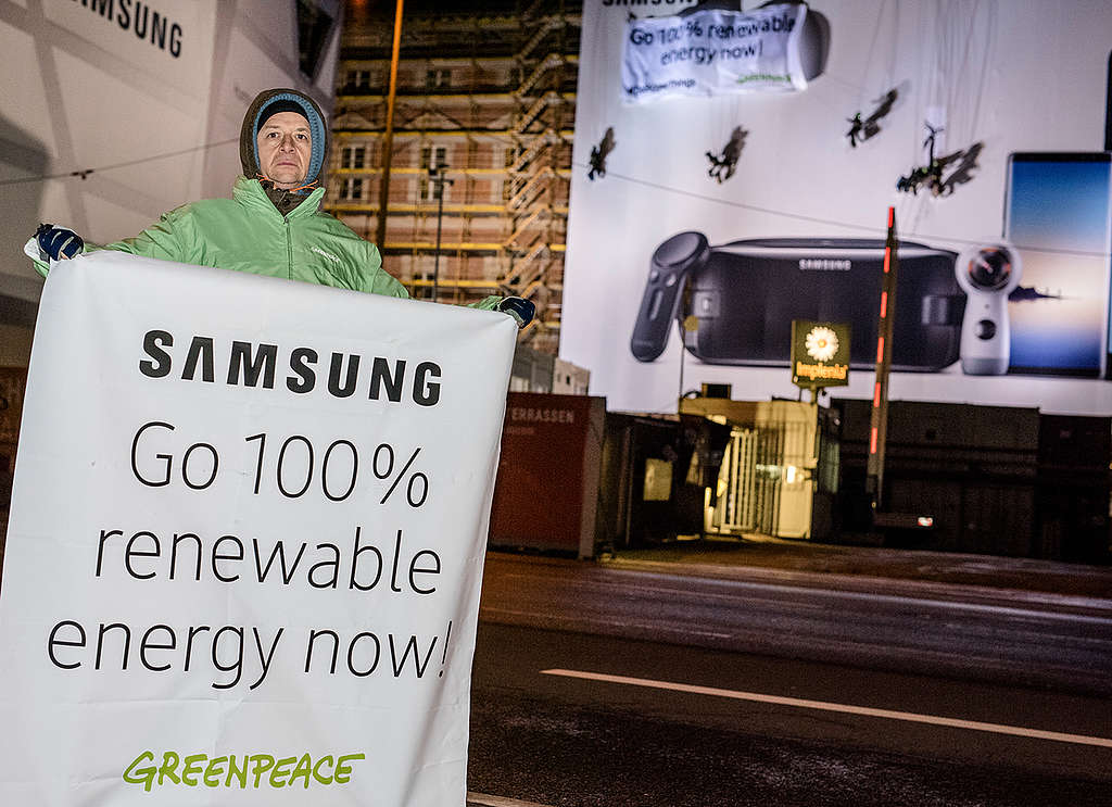 Ativista segura cartaz pedindo a Samsung 100% de energia limpa © Mike Schmidt