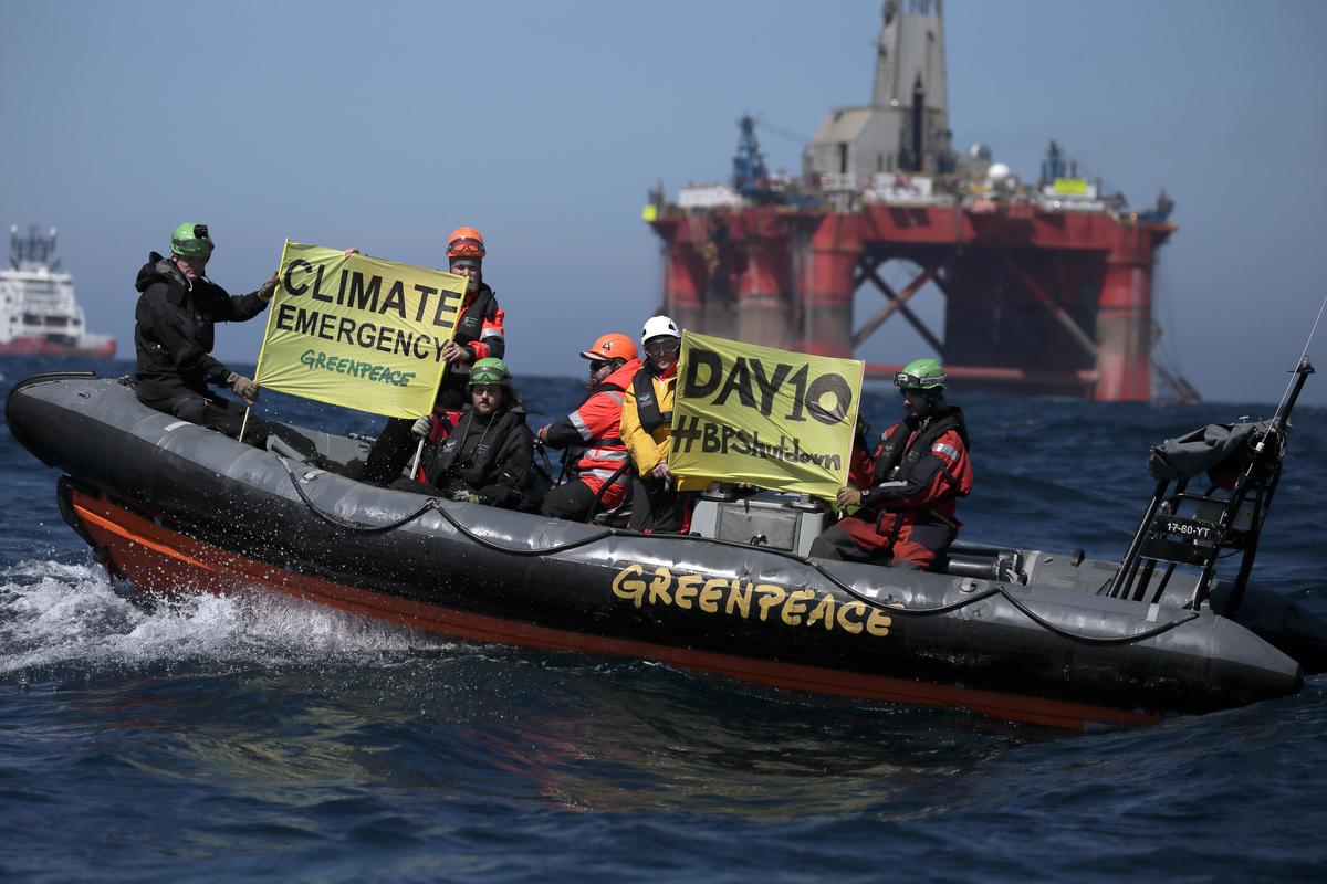 Ativistas a bordo de bote inflável com cartazes contendo “Emergência Climática”. © Greenpeace