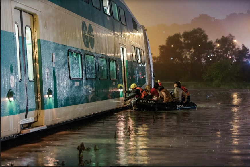Police boats rescue travellers on the GO Train in Toronto during the 2013 floods.
