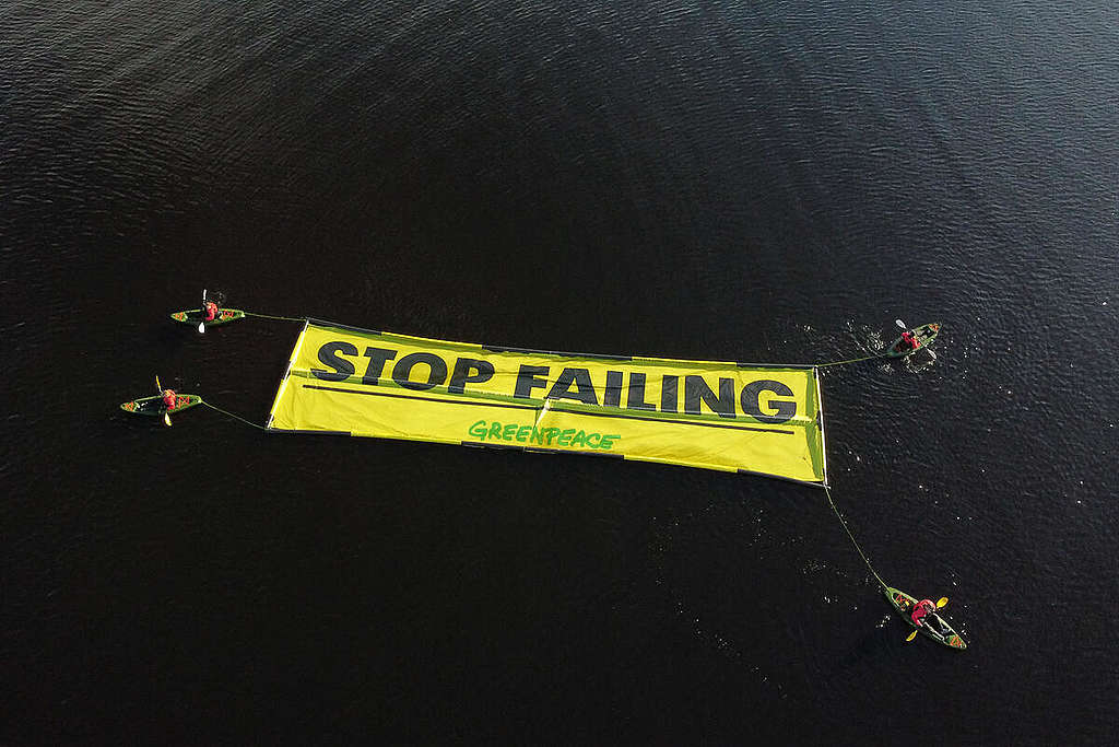 Kayakers with Floating Banner "Stop Failing" in Scotland.