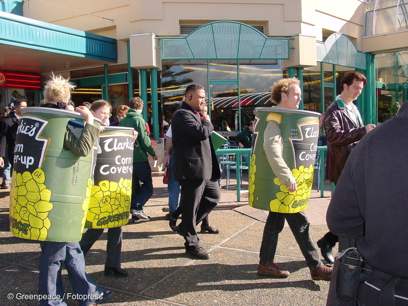 Greenpeace activists protest against the government's cover up of a GE corn contamination. The activists followed Labour Party leader Helen Clark during the 2002 election campaign, dressed in corn cans labelled “Clarkies' corn coverup”.