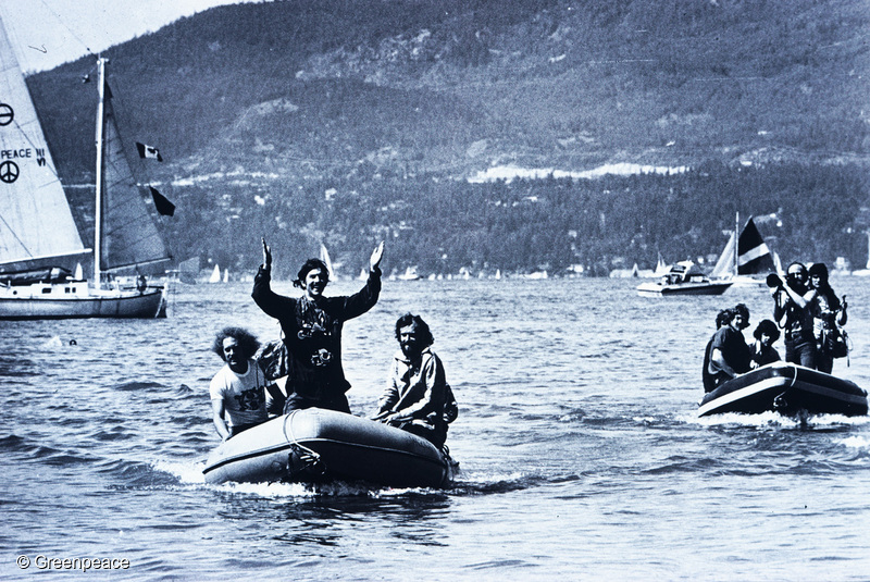 Rex Weyler (standing) with Bob Hunter on the right, as the Phyllis Cormack and crew return to Vancouver from the 1975 whale campaign. The Vega drifts in distance, to the left.