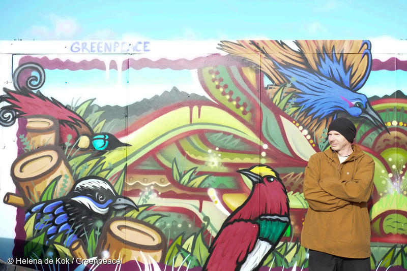 Portrait of street artist Sean Duffell, in front of the mural he painted depicting birds of paradise in Wellington, New Zealand. Part of the Greenpeace event, 'Wings of Paradise" highlighting deforestation in the Indonesian province of West Papua.