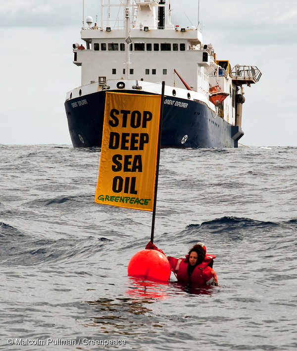 Greenpeace activist Kylie Matthews (Ngāpuhi) next to a buoy holding a banner reading "Stop deep sea oil" in front of the oil survey ship Orient Explorer to disrupt the seismic testing by Brazilian oil giant Petrobras in Raukumara Basin, off East Cape, North Island taken by Malcolm Pullman