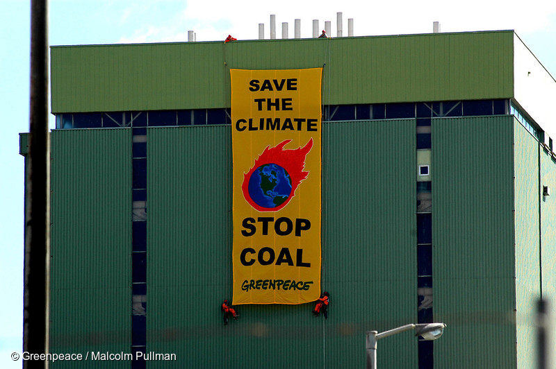On the day the Kyoto Protocol comes into force, Greenpeace activists hang a banner reading ‘Save the Climate  - Stop Coal’ on Marsden B power station.  A proposed conversion would change this power station from oil to coal fired which will emit 2 million tonnes of climate changing carbon dioxide each year.