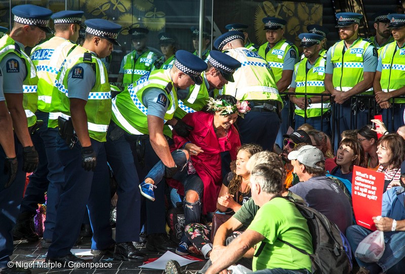 More than 200 people descended on New Zealand’s largest oil industry conference in Auckland and blocked its entrances as part of a Greenpeace-organised demonstration of peaceful civil disobedience. It‘s the first time in New Zealand that Greenpeace has invited the general public to take civil disobedience action en masse. Photo: Greenpeace/Nigel Marple