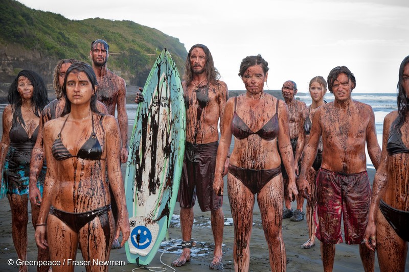 Greenpeace volunteers cover themselves in 'oil' at Muriwai beach to send a strong message to the Government to stop its plans for the drilling of new deep water oil wells off New Zealand's coast.