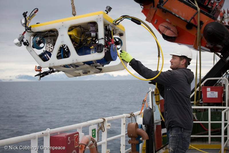 Sune Scheller from Denmark, campaign coordinator. Assisting crewmates of the Arctic Sunrise in launching an ROV to film the seabed of the Barents Sea off the coast of Svalbard.