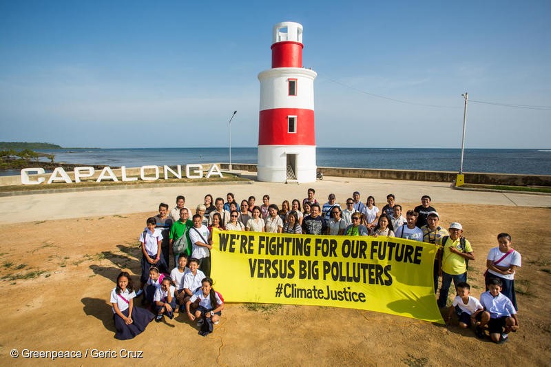 participants of the forum on Climate Change Adaptation and Mitigation pose for a photo op at the lighthouse in Capalonga, Camarines Sur. A resolution