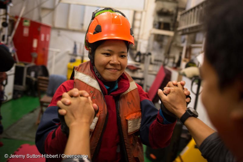 Atlantic Ocean, on 17 November 2018. - Activist Waya prepares to leave the MV Esperanza to begin their boarding action on a giant tanker ship carrying dirty palm oil from Indonesia to Europe in a peaceful protest against rainforest destruction.Trained Greenpeace climbers from Indonesia, Germany, the UK, France, Canada and the US, have safely scaled the side of Stolt Tenacity and aim to stay on board until it arrives at its final destination in Rotterdam.The 185-metre long cargo ship is loaded with palm oil from Wilmar, the largest and dirtiest palm oil trader in the world.