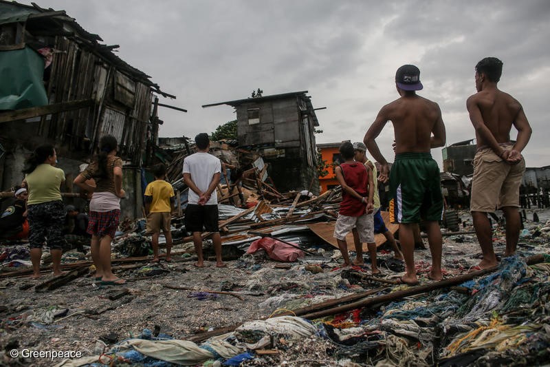 People look for recyclable materials after their houses were destroyed by strong winds and waves along the shores of Navotas in Manila, Philippines on Monday. August 13, 2018. Heavy rainfall and strong winds brought by the southwest monsoon enhanced by tropical storm Yagi, displaced thousands of people and left many parts of the metro flooded over the weekend.