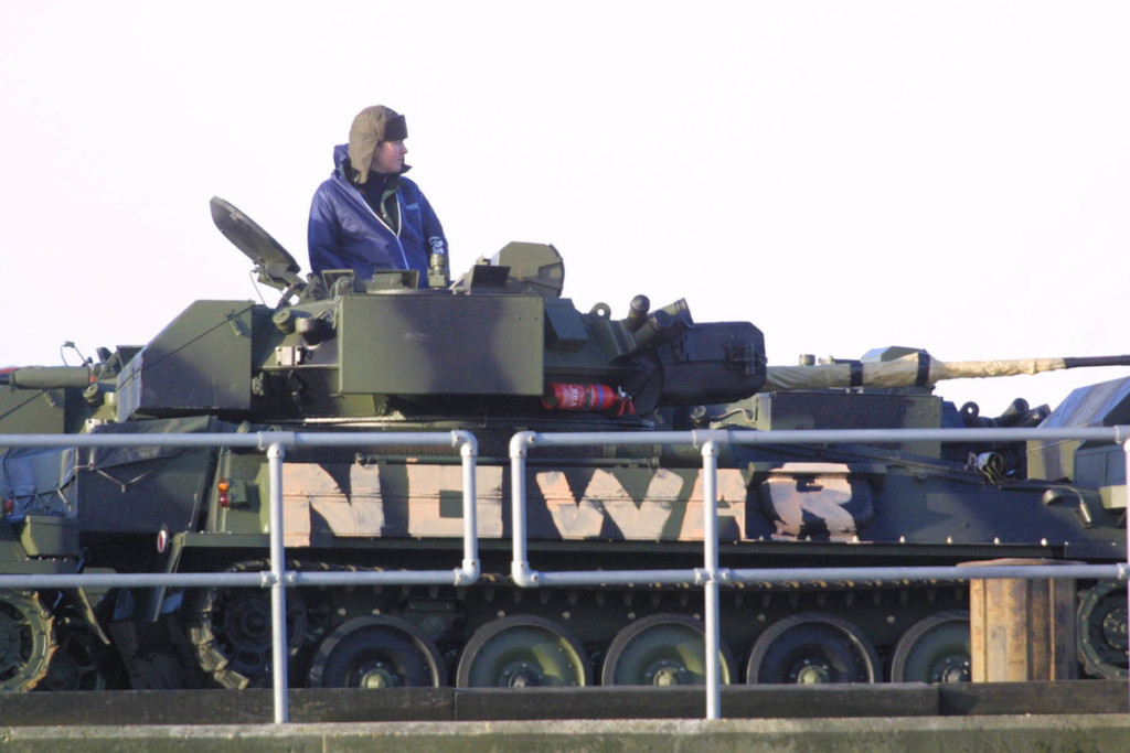 Activists on a military tank in the UK, 2003 © David Sims / Greenpeace © David Sims / Greenpeace