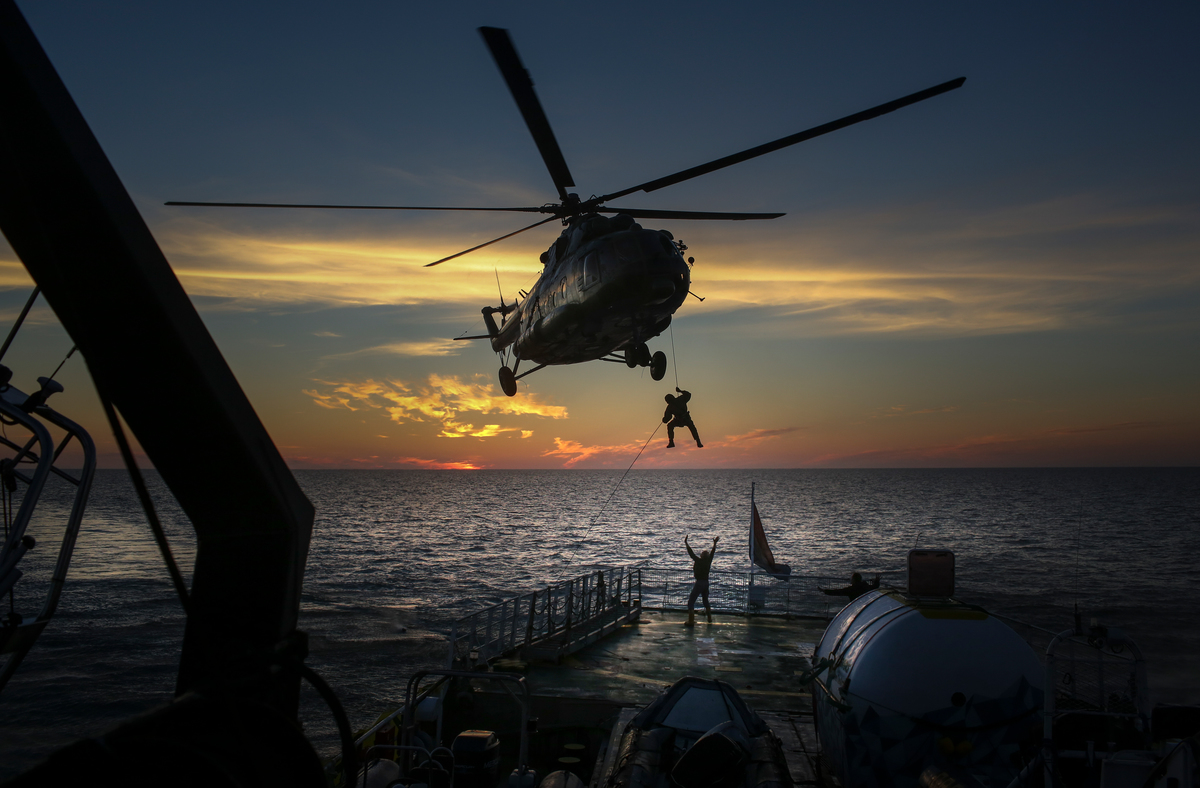 Russian security services abseil from a helicopter onto the deck of the Arctic Sunrise ship and seize the ship and crew at gunpoint (19 September, 2013)