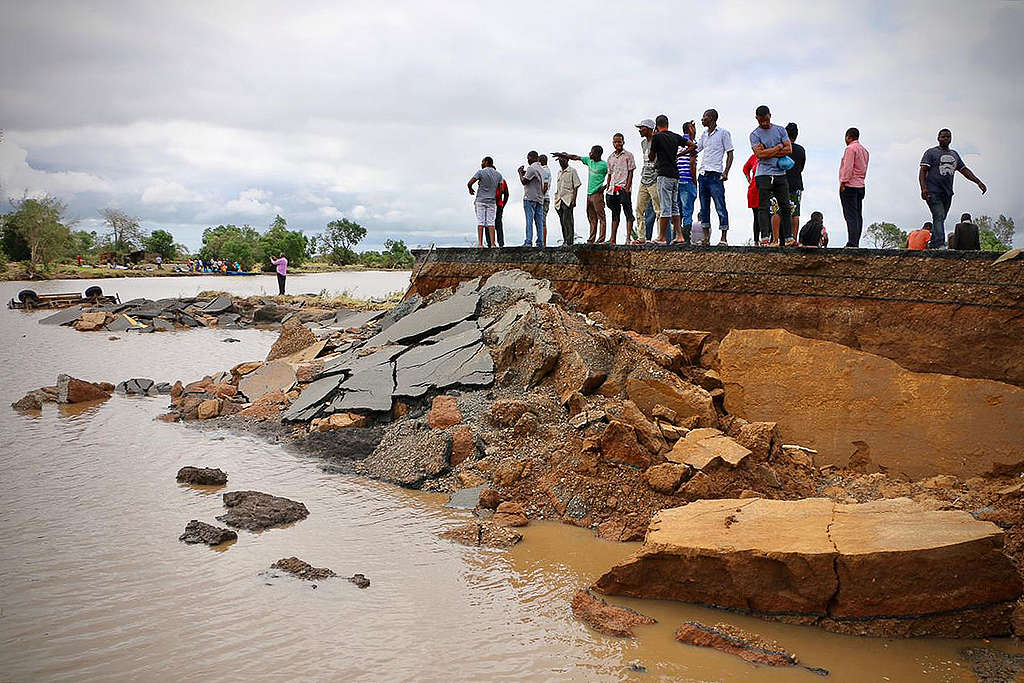 Locals stand beside a damaged section of the road between Beira and Chimoio © ADRIEN BARBIER/AFP/Getty Images