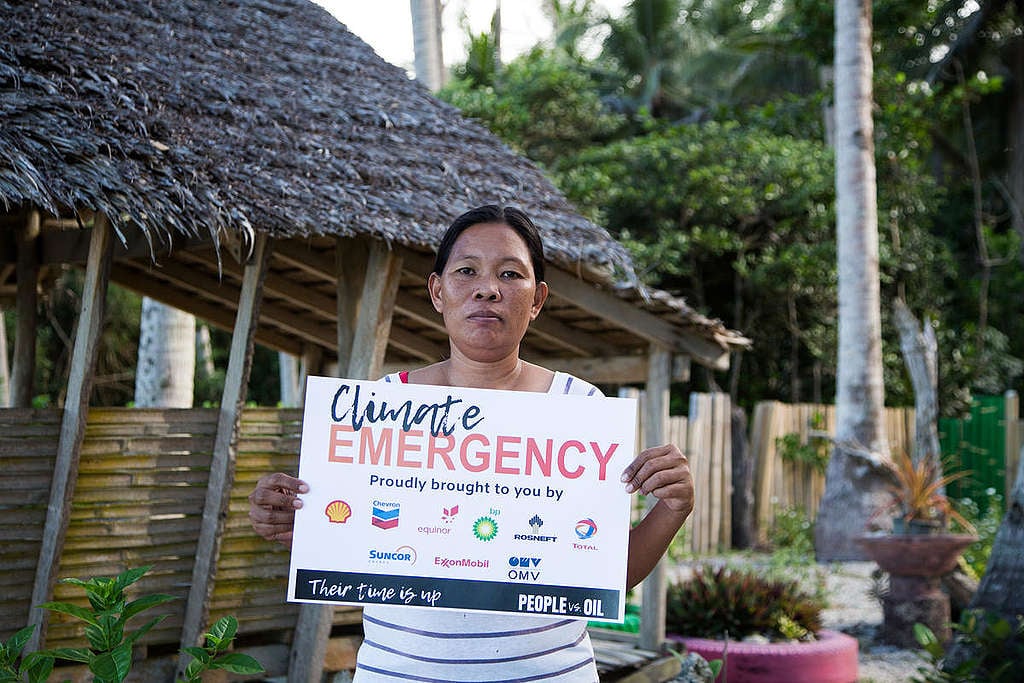 Activists reclaim public space in Alabat, Quezon with climate emergency “advertisements”. © Greenpeace
