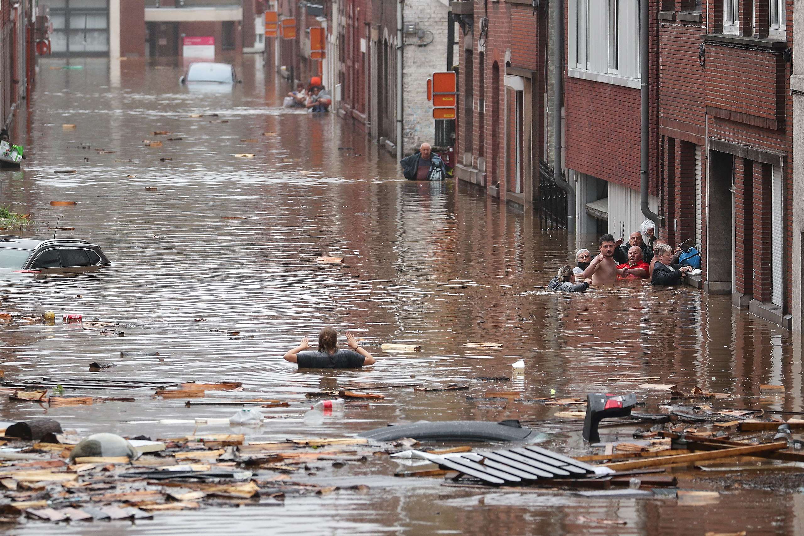 A woman is trying to move in a flooded street following heavy rains in Liege. © Bruno Fahy/Belga/AFP / Getty Images