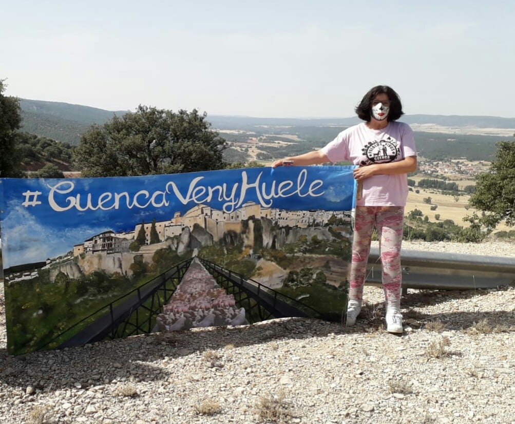 Remedios Bobillo Jimenez (Mota del Cuervo, Cuenca, Castilla la Mancha) stands with a banner protesting against the smell and pollution caused by a factory farm. © Remedios Bobillo Jimenez