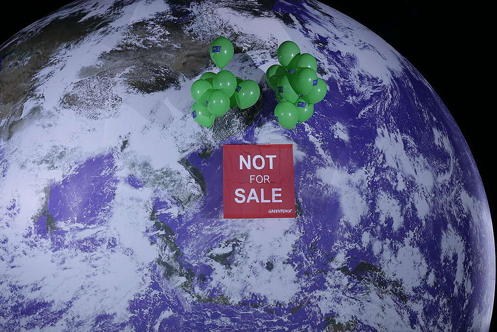 NOT FOR SALE” Banner Against Iconic Giant Globe At COP26 In Glasgow. © Emily Macinnes / Greenpeace
