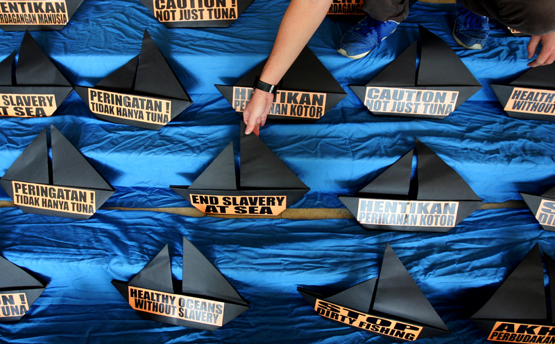 Activist arranges origami of boats during the protest in front of the Ministry of Manpower, Jakarta.
