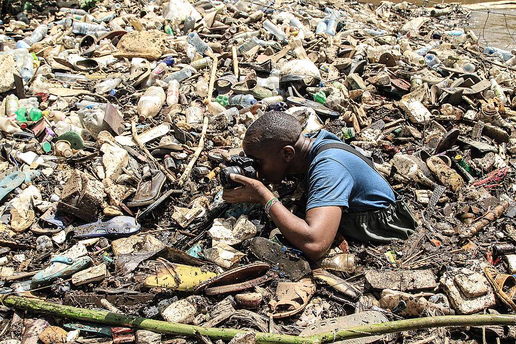 James, documenting plastic pollution in Kenya. © Bedan Mwihia
