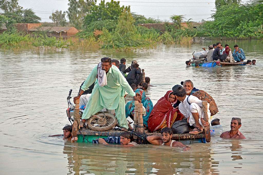 Internally displaced people wade through floodwaters after heavy monsoon rains in Balochistan province on Pakistan. File photo from September 8, 2022. - Photo by FIDA HUSSAIN/AFP via Getty Images
