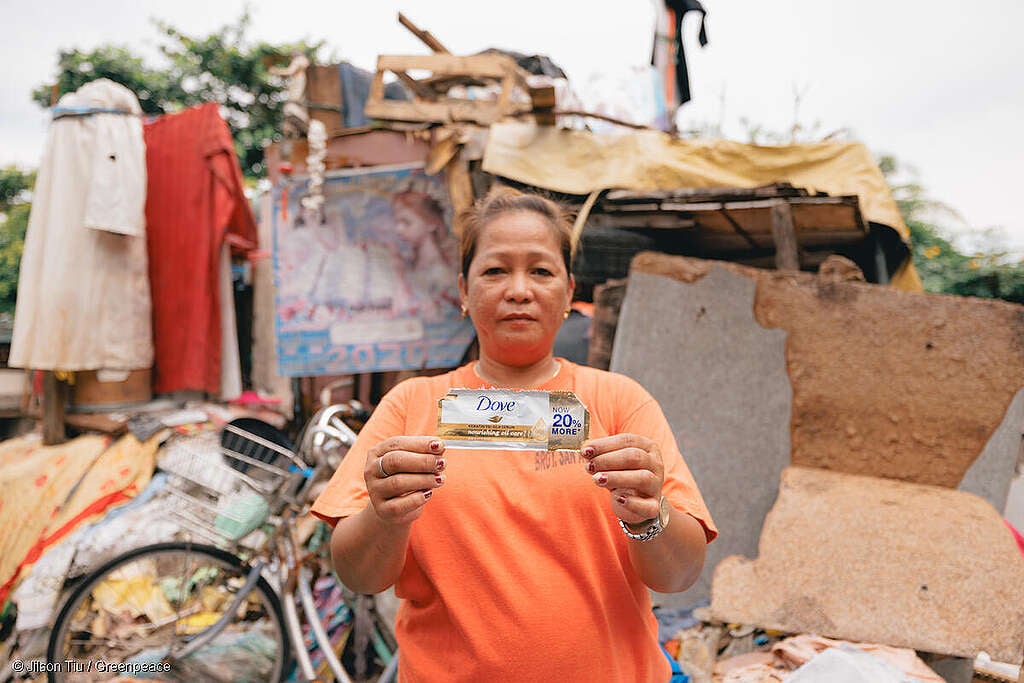 Plastic Waste Investigation in the Philippines
A street sweeper and waste worker Marilou Manangat, a mother of 4, who lives by the river dumpsite and oil factory holds a Dove sachet packaging by her place as she uses the shampoo personally.