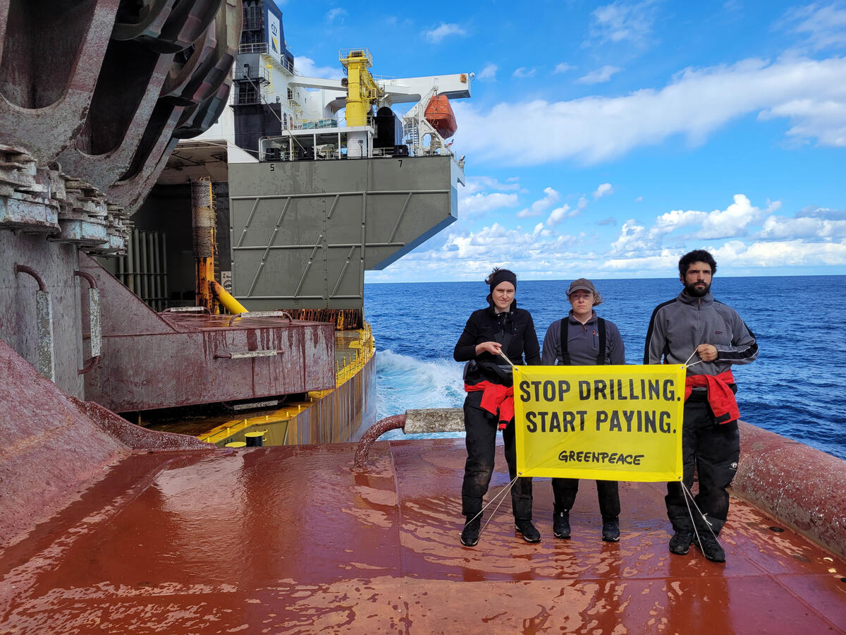 Greenpeace climate justice activists occupy Shell platform en route to major oilfield with the message: ‘STOP DRILLING. START PAYING.’ © Greenpeace