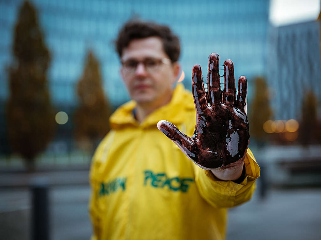 In Austria, activists are pictured outside fossil fuel company OMV’s headquarters in Vienna, demanding the company stops oil and gas extraction and pays reparations to communities it has damaged.