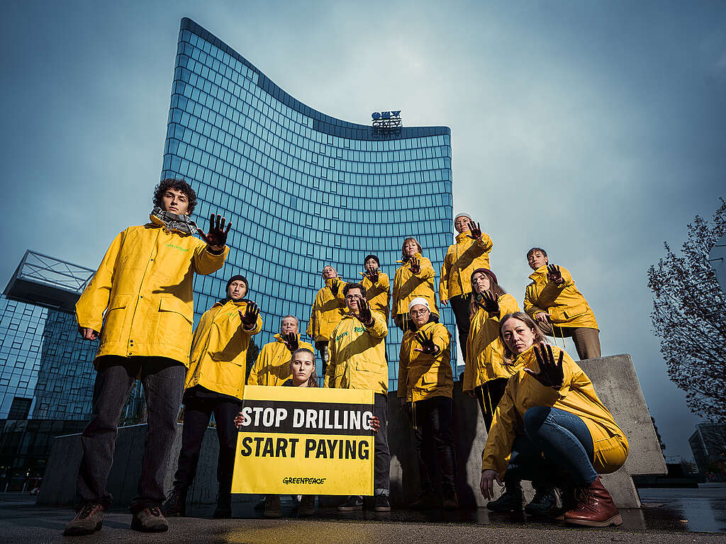In Austria, activists are pictured outside fossil fuel company OMV’s headquarters in Vienna, demanding the company stops oil and gas extraction and pays reparations to communities it has damaged.