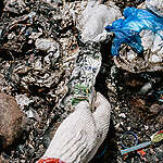 Marine Scientist and local organiser against plastic waste in her community, Laras Nauna. Laras holds a discarded Dove bottle during a beach clean-up with the Sahabat Laut Community. They are cleaning up and recording waste. 
Lampuuk beach, Aceh Besar Regency, Indonesia.