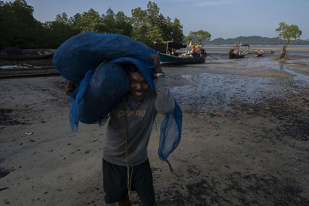 A fisherman from Koh Phayam, Ranong Province carries a fishing net