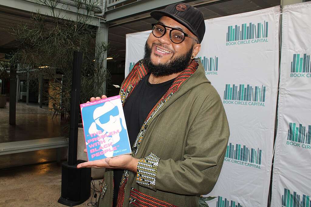 Louw with a copy of his book at its launch this year © Greenpeace