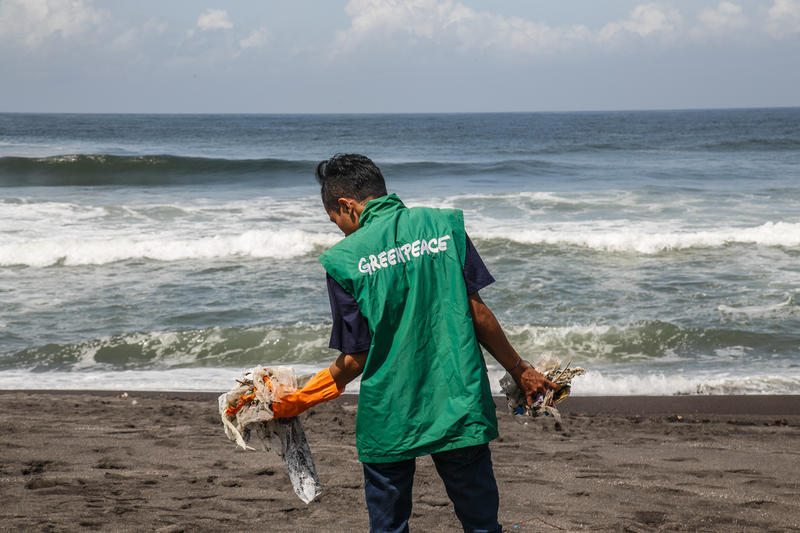 Un voluntario de Greenpeace recoge y audita basura plástica durante una actividad de limpieza de playas en la playa de Padansari, Bantul, Yogyakarta.