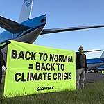 Activists cycle on airport runway demanding climate conditions for bailout