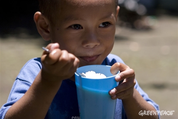 A young boy happily eats his organic rice for lunch at Sitio Canaan, Barangay Crossing, Magallon, Negros Occidental.
