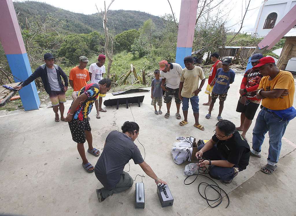 Installation of portable solar power in Kambubuyugan, Brgy. Kalawakan © Bullit Marquez