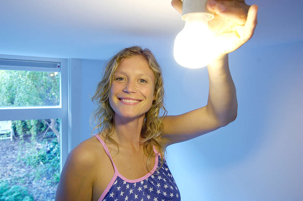 Portrait of Sophie Hilbrand with Low Energy Light Bulb. © Greenpeace / Rob Marinissen