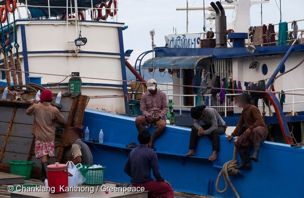  Workers take a break after unloading fish from Sor Somboon 19. Initial screenings conducted by Greenpeace revealed that crew from this Thai trawler met internationally-accepted definitions of forced labour.