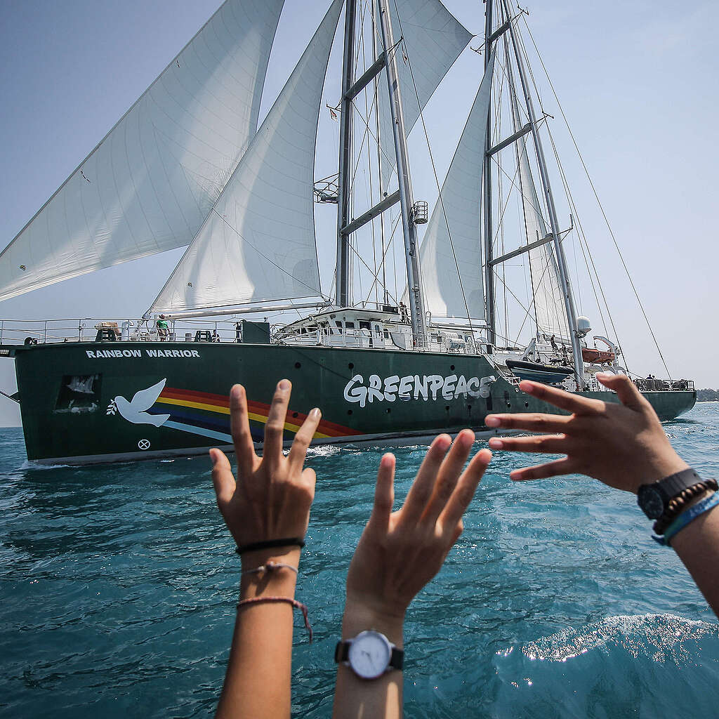 Greenpeace Rainbow Warrior ship joins with dozens of fishermen boats of Pari island as they hold an action to save Pari island in Thousands Islands, North Jakarta.