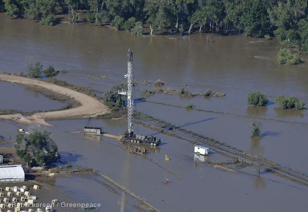 An oil operation remains under water by a washed-out rail line on the South Platte River near Greeley